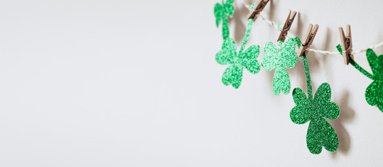 Happy St. Patricks day background with Green glitter shamrocks decoration, banner format