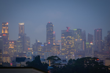 Fototapeta na wymiar Blurry city scape of public housing in central Singapore, light bokeh during blue hour