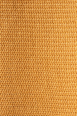 Mustard knitted background, fragment of knitwear