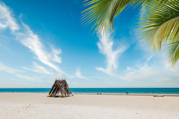 Beautiful Seascape tropical beach background. White sand with palm tree and blur bokeh light of calm sea and sky. summer vacation background concept.