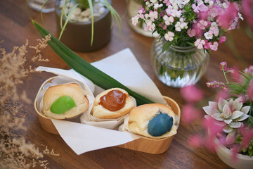 Buns. Pandanus leaf custard bun with top view and soft focus on the brown fillings which is Thai Tea flavour. Green is pandanus custard cream and blue is butterfly pea custard cream