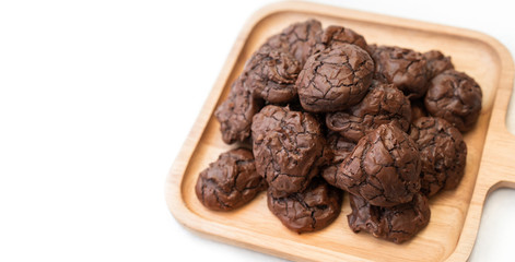 chocolate cookies on wooden plate isolated on white background.