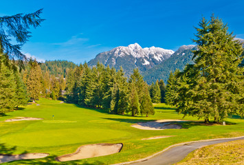 Golf place with nice green and gorgeous mountain view.