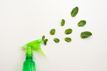 Detergent green bottle on a pink background spray a fresh mint leaves. - Copy space © speed300