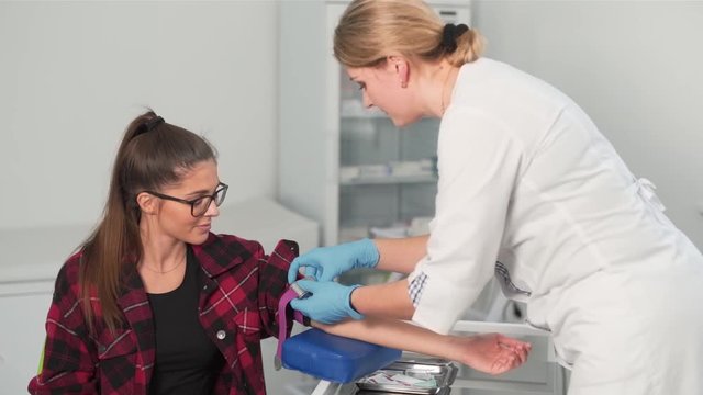 doctor prepares girl for blood test from vein
