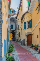 Fototapeta na wymiar Colorful old buildings of a hilltop medieval town of Ventimiglia in Italy across from the French border