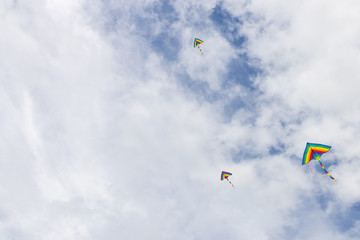 Coloful kites flying against blue sky with copy space
