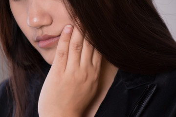 Close-up asian woman with suffering from toothache, tooth decay or sensitivity. Healthcare concept.
