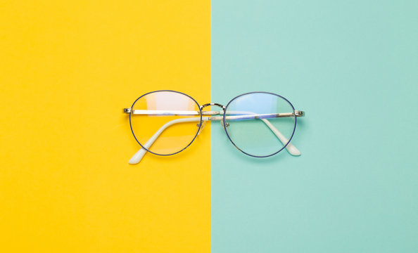 Eye glasses isolated on yellow and blue background.