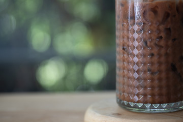 Glass of iced cocoa on wood table