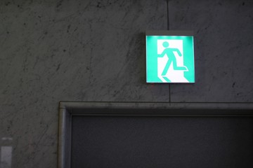 green exit sign on the wall
