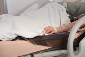Fototapeta premium Focus on the hand of a patient in hospital room