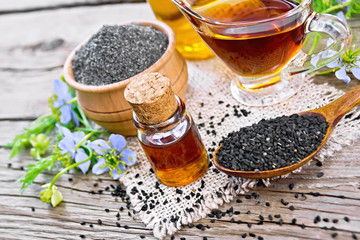 Oil kalingi in bottles and gravy boat on old board