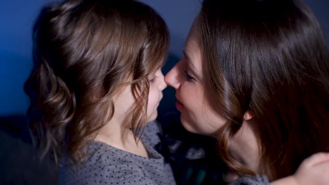 Mom And Daughter In The Studio Are Photographed Sitting On The Floor