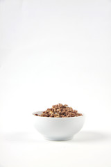 a bowl of granola isolated on white background. Vertical image