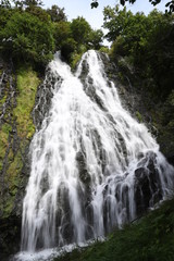 Fototapeta na wymiar 知床八景オシンコシンの滝: 北海道道東の日本の滝百選のひとつ（名瀑）