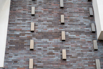 Brick building wall with decorative protruding bricks