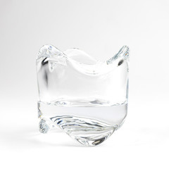 Empty burning glass candle, on white background.