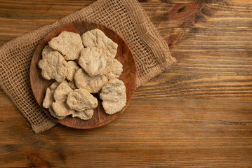 Raw Dehydrated Soy Meat or Soya Chunks on Wood Background