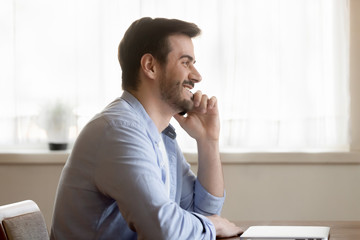 Smiling Caucasian man talk on cell using wireless internet