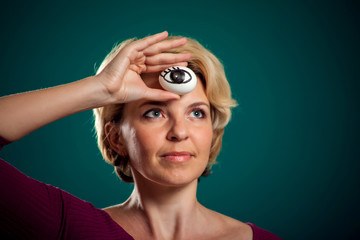 A portrait woman holding egg with drawing eye. Third eye concept