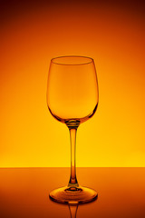 Wine glass on a yellow-orange background with a gradient
