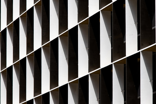 Black And White Building Facade Under Light And Shadow.