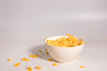 Corn flakes falling to the white bowl. Motion.