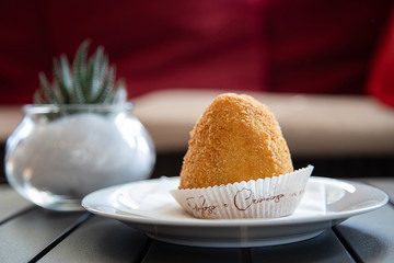 Arancino or arancina, tipical and traditional sicilian street food.  Delicious rice balls made with fried rice.
