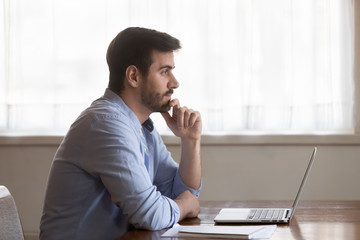 Pensive male look in distance thinking of problem solution