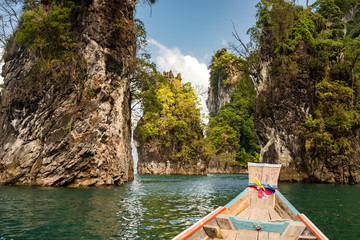 Wooden thai longtail boat on Cheow Lan lake in Khao Sok National Park, Thailand