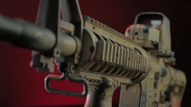 military rifle with a silencer in the smoke