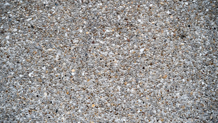 Cement wall made of small brown stones mixed together