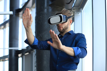 Shot of an engineer wearing a VR headset in an new building. Change the way you see and experience the world.