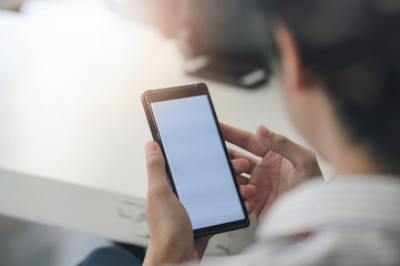 Man hand using smartphone with blank screen.