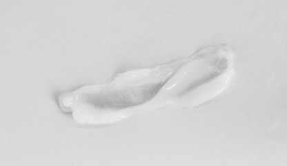 close up of white cream sample on white background