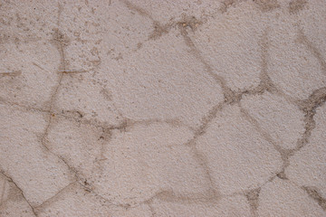 Old cement walls outside the building with cracks and mold stains.