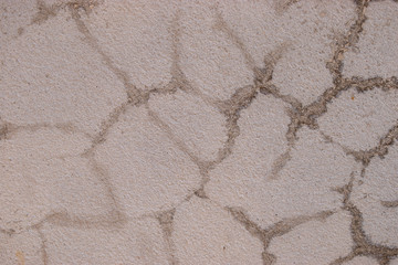 Old cement walls outside the building with cracks and mold stains.