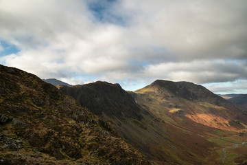 Epic Autumn Fall landscape image of mountain peaks in Lake District near Buttermere with gorgeous light across ridge