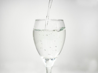 Pour water into the glass until small bubbles of various shapes are formed. White background