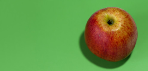 ripe raw red apple on an green background, top view fruit healthy eating background.
