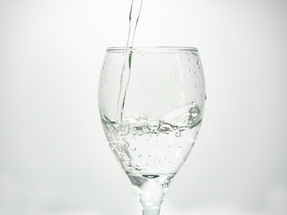 Pour water into the glass until small bubbles of various shapes are formed. White background