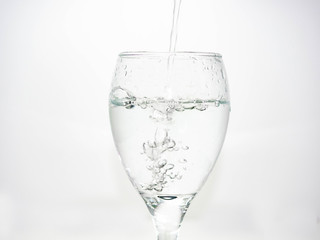 Pour water into the glass until small bubbles of various shapes are formed. White background