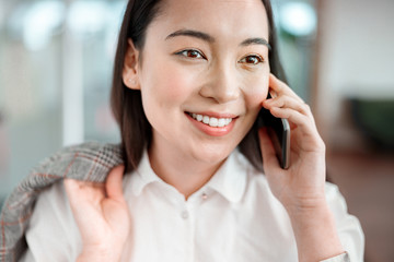 Asian young woman is woking in office