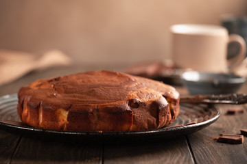 Homemade baking. Fragrant zebra cake with a crispy crust on a plate with coffee and chocolate