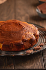 Homemade baking. Fragrant zebra cake with a crispy crust on a plate with coffee and chocolate