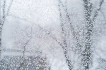 Snowfall. The texture of a snowy window. Snowflakes adhered to the glass.