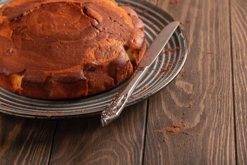Homemade baking. Fragrant zebra cake with a crispy crust on a plate with coffee and chocolate