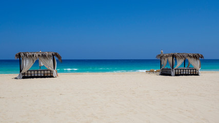 Marsa Matruh, Egypt. Elegant gazebo on the beach. Amazing sea with tropical blue, turquoise and green colors. Relaxing context. Nobody on the beach. Fabulous holidays. Mediterranean Sea. North Africa