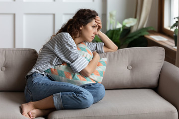 Lost in thoughts unhappy stressed woman regretting of wrong decision.